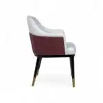 Luxurious modern accent chair with velvet upholstery and gold-tipped wooden legs.
