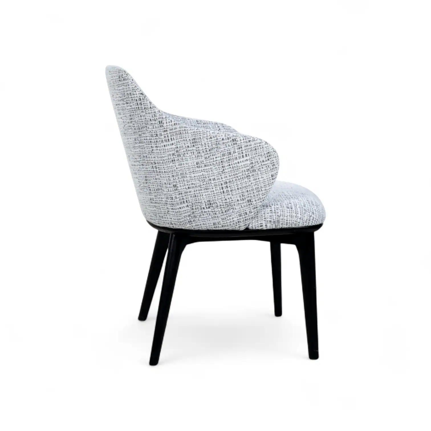 Elegant modern armchair with black wooden legs and textured fabric upholstery for contemporary home decor.