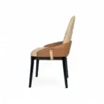 Elegant modern dining chair with beige and tan faux leather upholstery and black wooden legs.