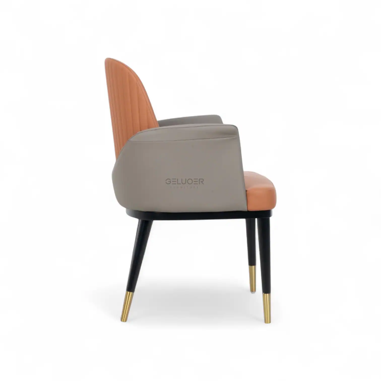 Modern upholstered dining chair with a beige and peach leather finish, black wooden legs with gold tips.