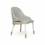 Luxurious white upholstered dining chair with gold accents, modern elegant furniture piece.