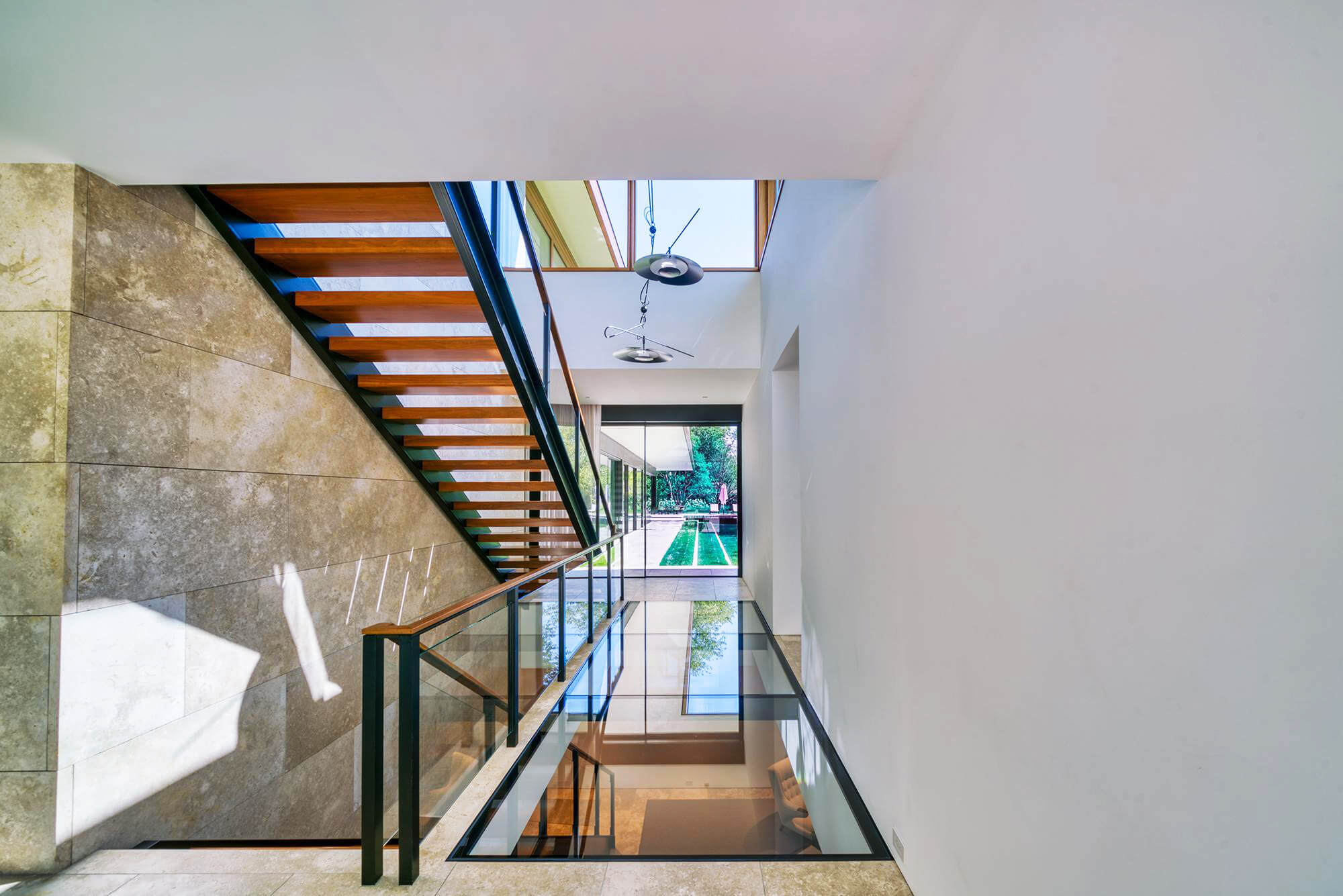 Interior staircase and glass catwalk with structural glass flooring panels