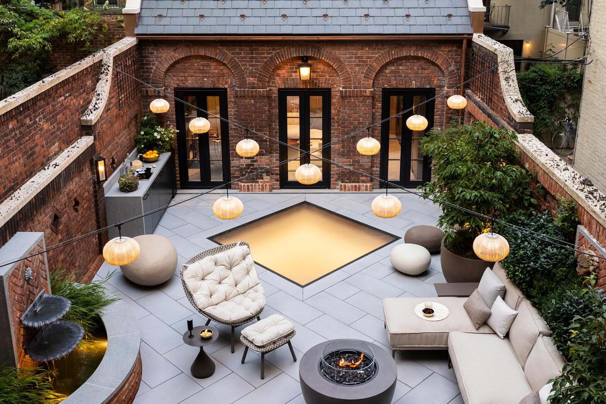 Brick courtyard patio with a SkyFloor walkable skylight set into the paving