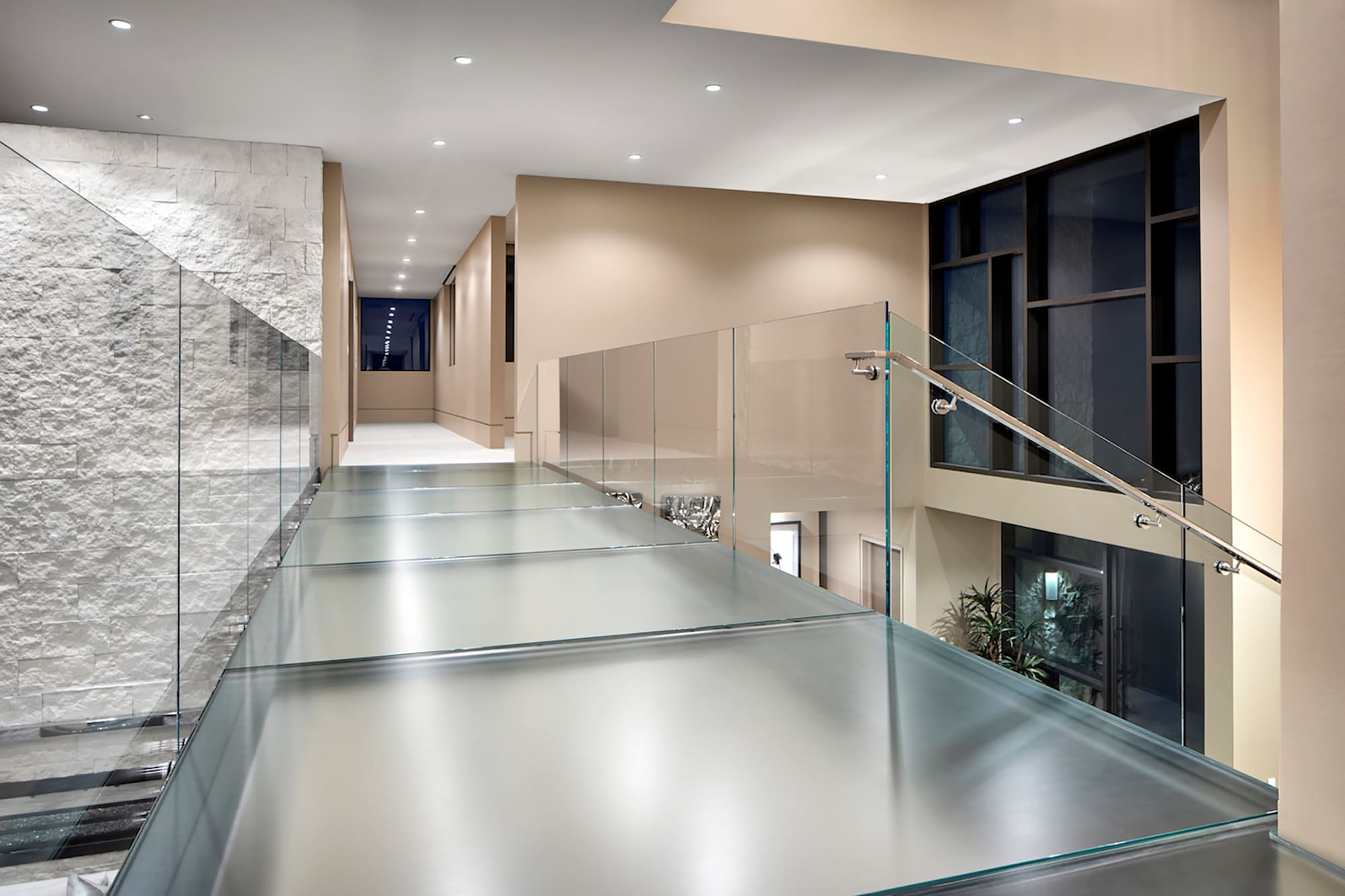 Residential interior with textured anti-slip glass stair treads and walkable glass flooring by Glass Flooring Systems