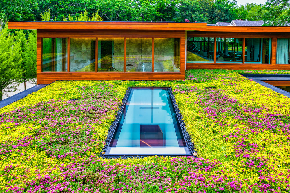 Modern home with a planted green roof and a recessed SkyFloor walkable skylight