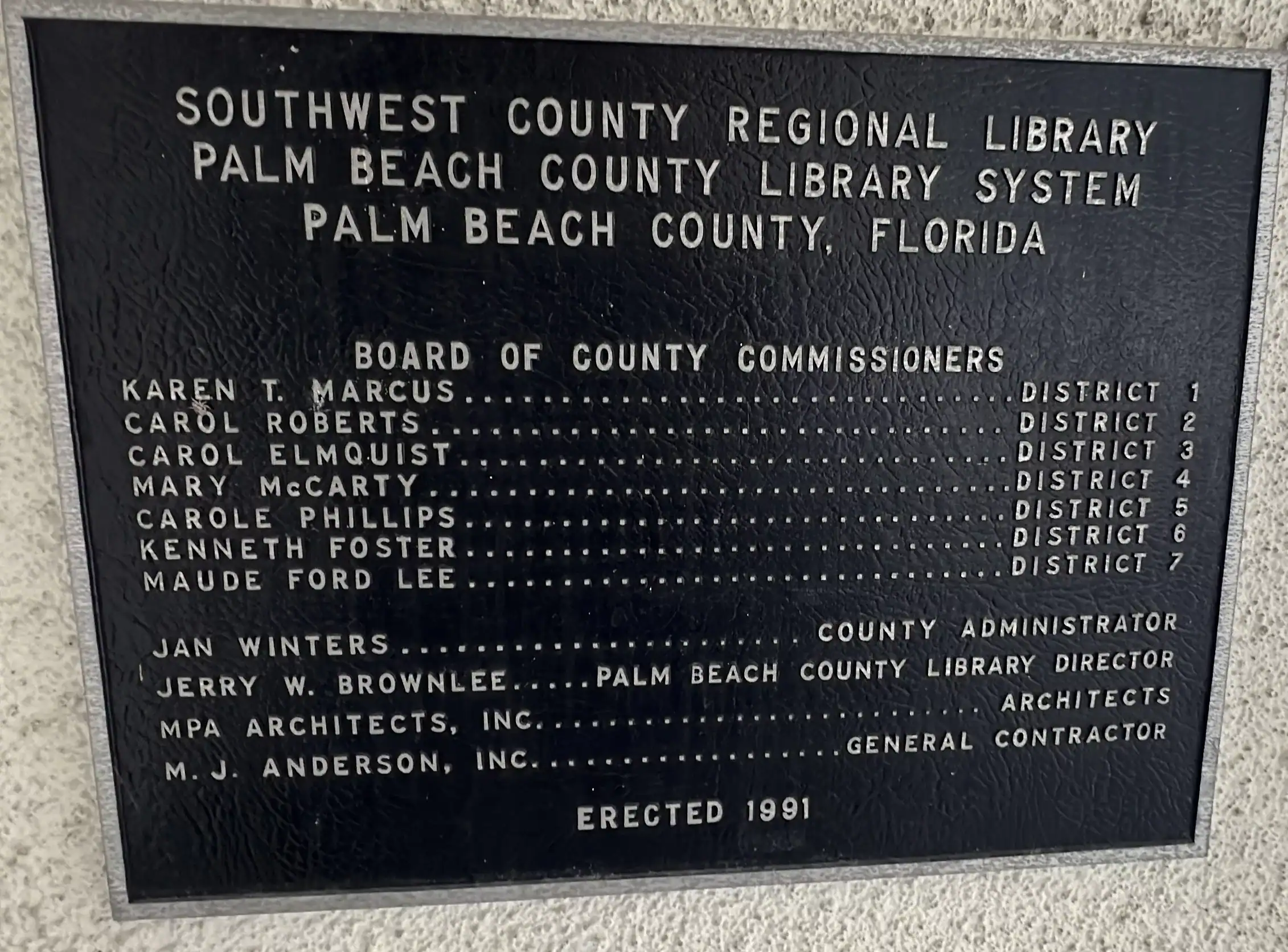 Plaque showing who the board of county commissioners were when the library was built. Palm Beach County Library Glades Road GCNN Good Citizen News Network goodcitizennewsnetwork.com News That's Not Fake