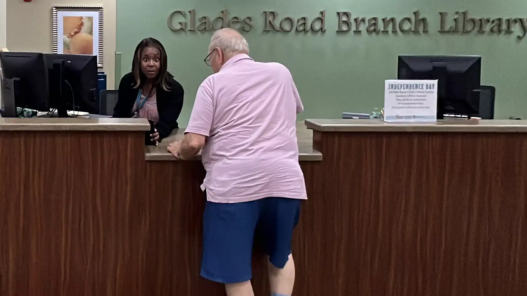 Library worker looks surprised that I took her picture. Palm Beach County Library Glades Road GCNN Good Citizen News Network goodcitizennewsnetwork.com News That's Not Fake