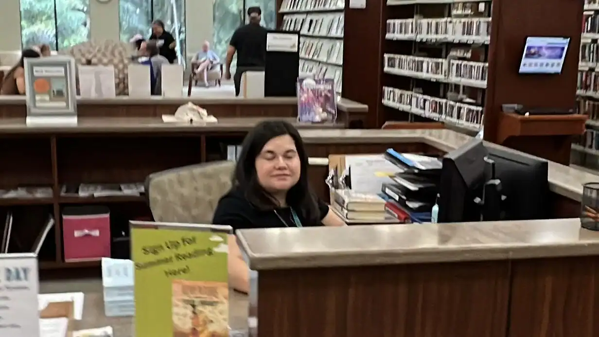 Library worker doing her job. Palm Beach County Library Glades Road GCNN Good Citizen News Network goodcitizennewsnetwork.com News That's Not Fake