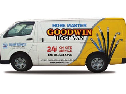 Service van for hoses and fittings with company branding and contact info.