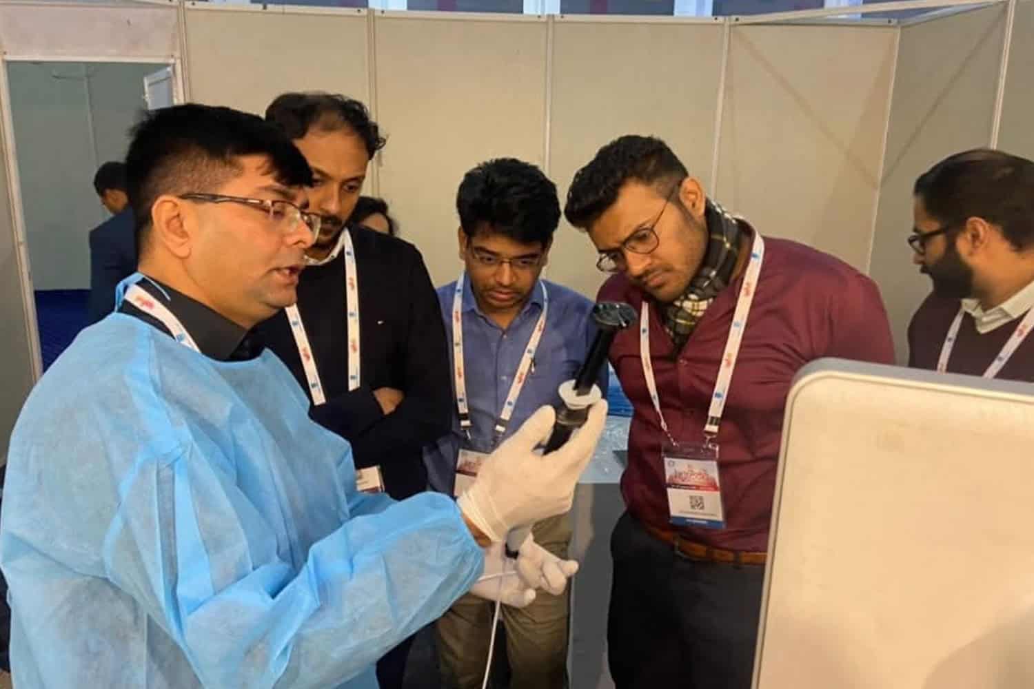 Doctor demonstrating medical procedure to a group at a healthcare event.