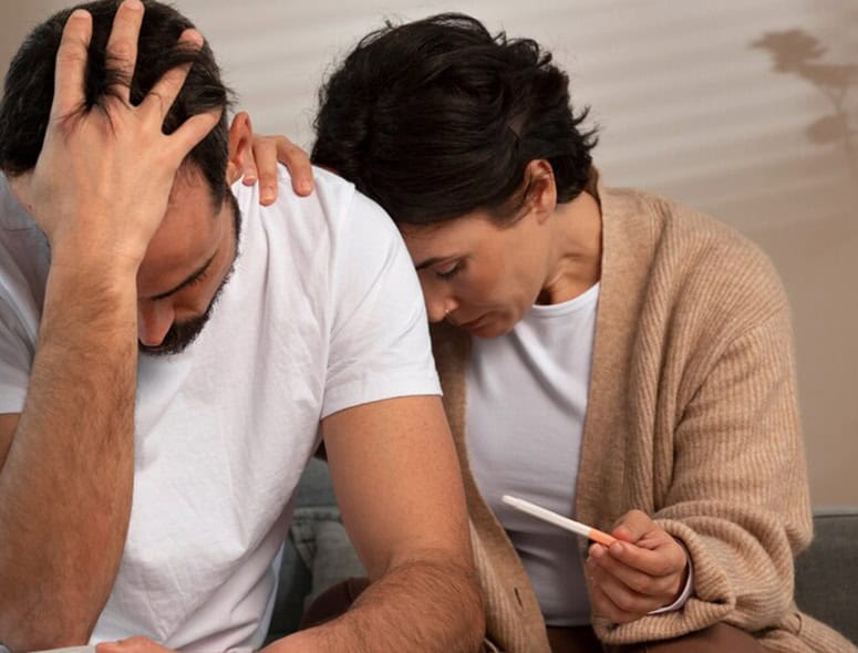 Couple distressed during fertility consultation at Grover Gastro and Fertility Centre.