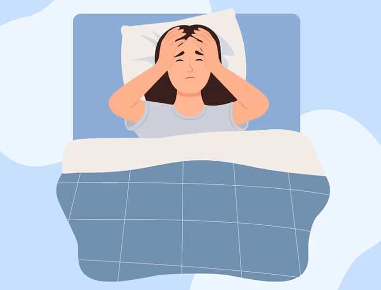 Woman in bed experiencing stress or discomfort, possibly related to PCOD symptoms.