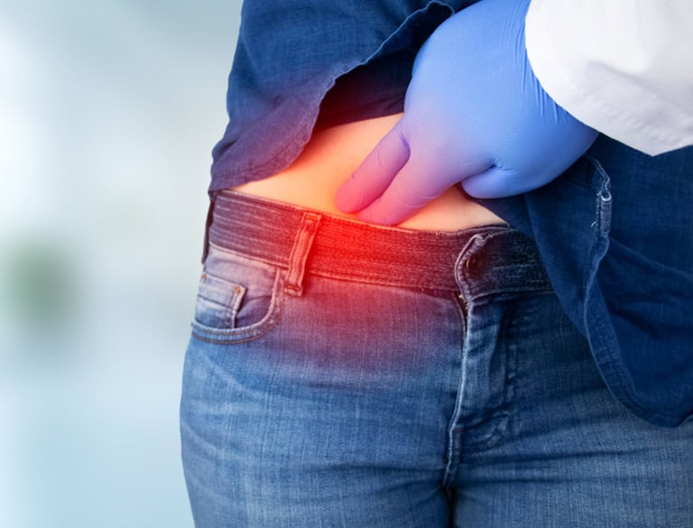 Person experiencing abdominal pain indicating possible appendicitis.