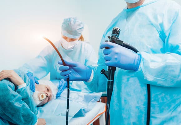 Medical team performing endoscopy procedure in hospital setting.