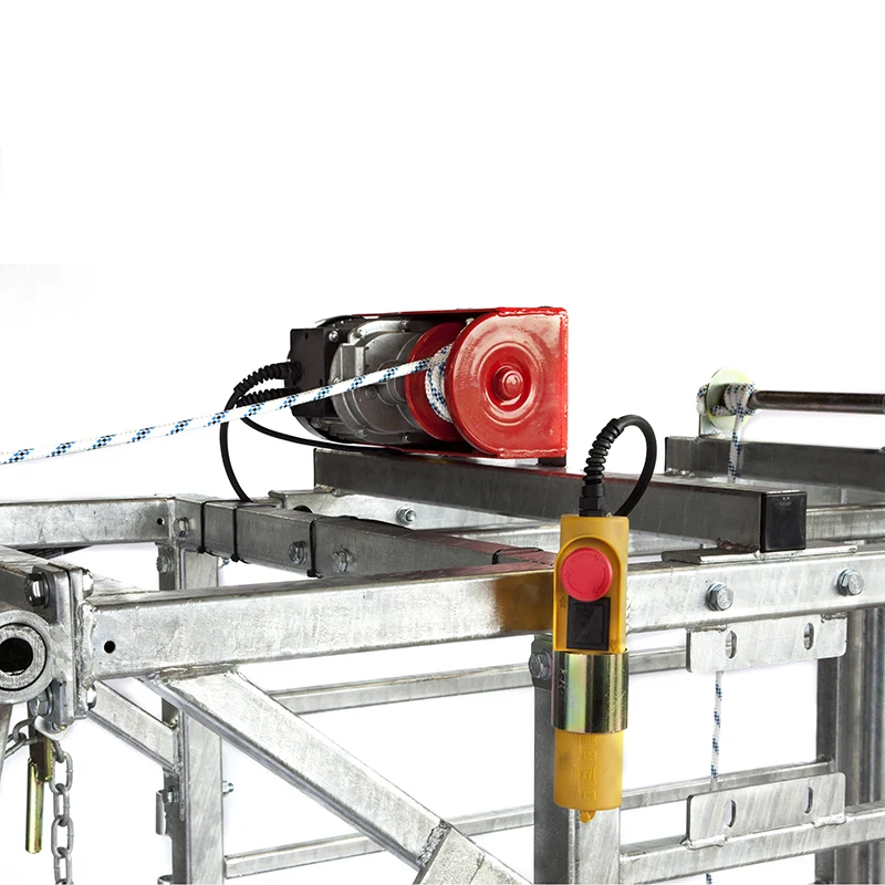 Electric winch with control buttons on steel frame.