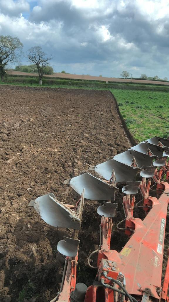 Plow turning soil in a rural field