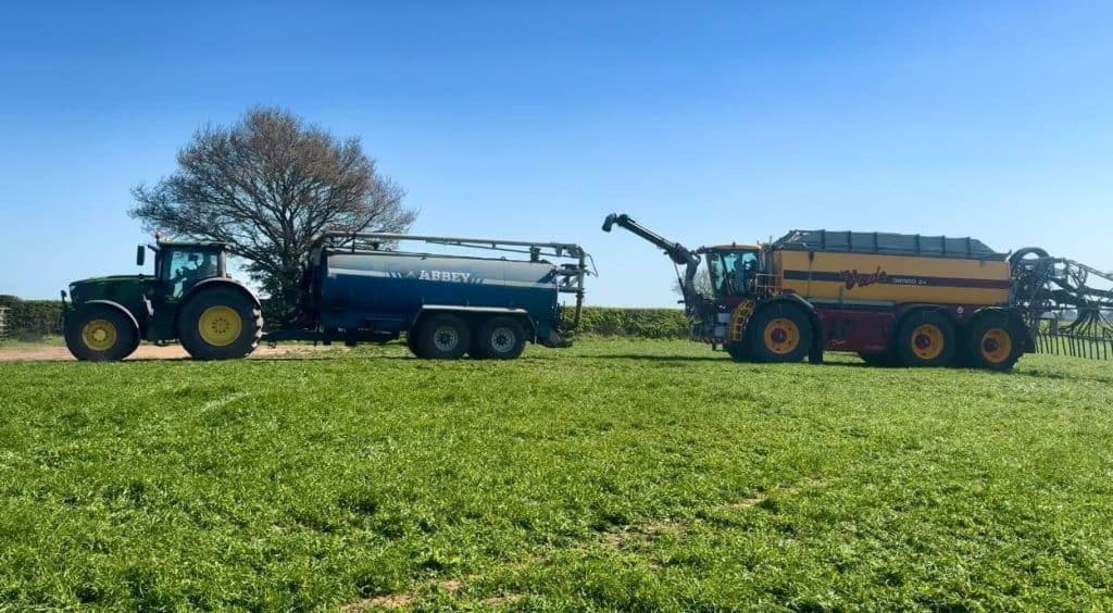 Tractor and machine on a grassy field
