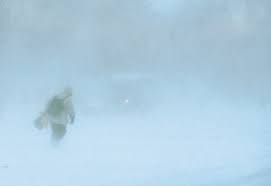image of man walking in a blizzard