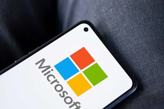 Microsoft logo on a smartphone screen, highlighting technology solutions.
