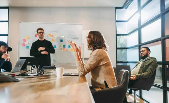 Business team discussing IT strategies in a modern conference room.
