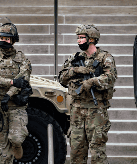 Military soldiers in camouflage gear during training or deployment.