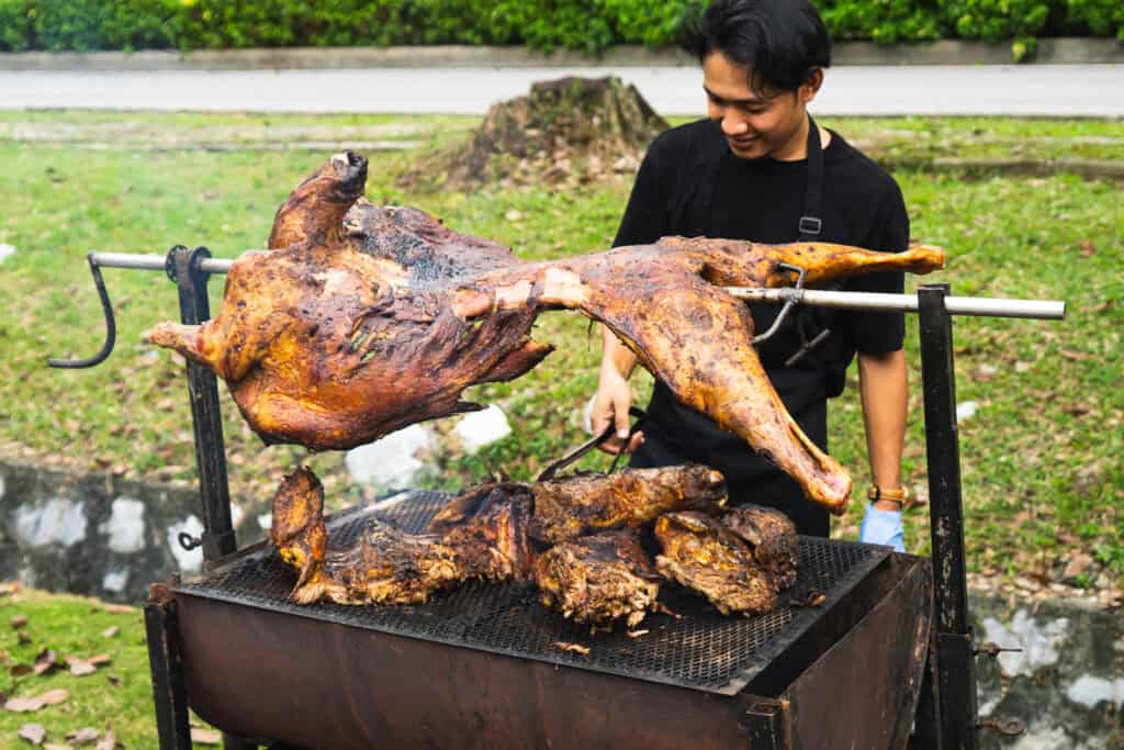 Halal food live station with lamb carving for Hari Raya catering, prepared by iDo Catering.