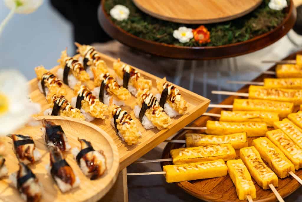 Japanese live sushi station served on wooden plate for wedding catering