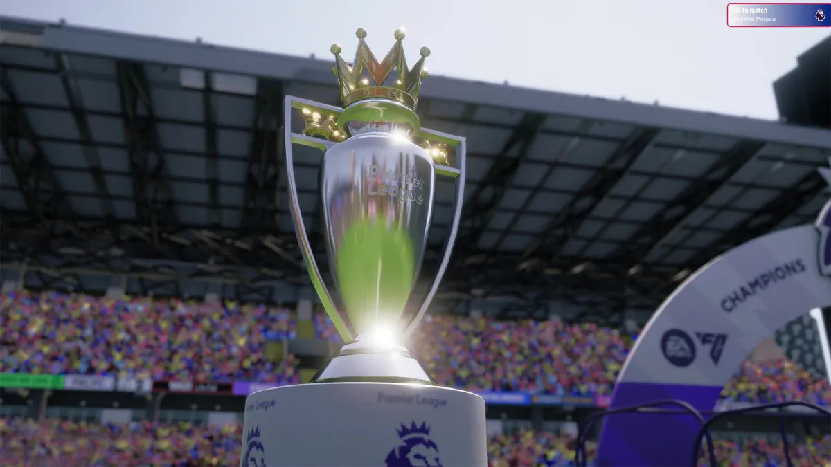 The Premier League trophy in a packed stadium in Football Manager 26
