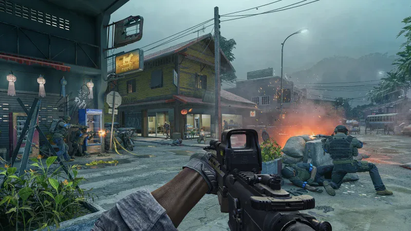 A first-person firefight in a rain-soaked town street with an explosion behind cover in Gray Zone Warfare