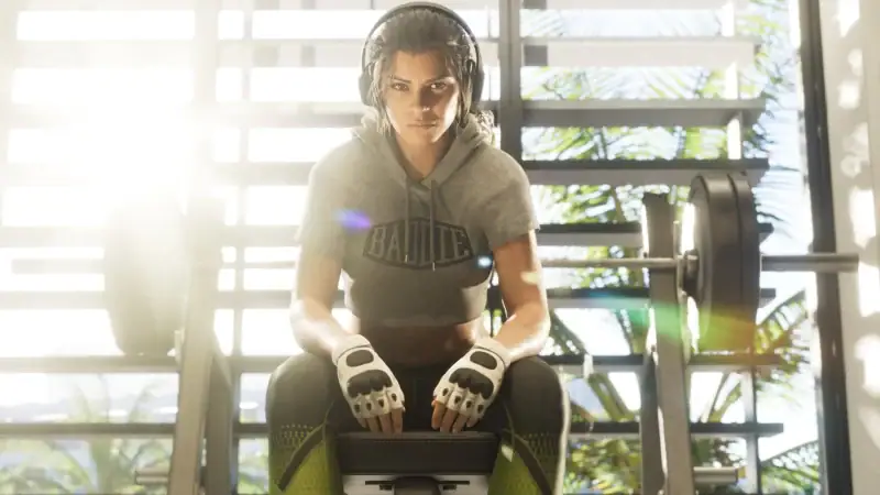 Lucia Caminos sits at a weight bench wearing headphones in Grand Theft Auto VI