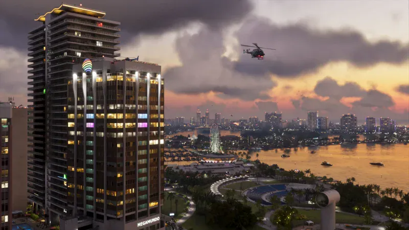 The Vice City skyline and bay at sunset with a helicopter overhead in Grand Theft Auto VI
