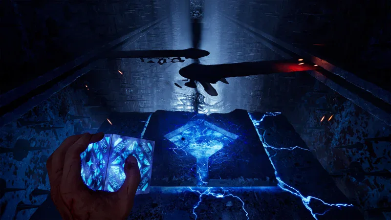 A hand holds the glowing Genesis Configuration puzzle box over a lit floor panel in Hellraiser: Revival