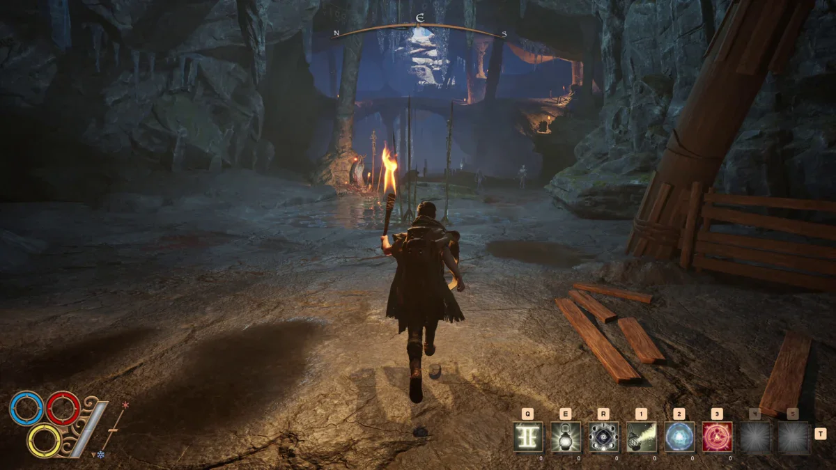 An adventurer carrying a torch walks into a dark cave in Outward 2