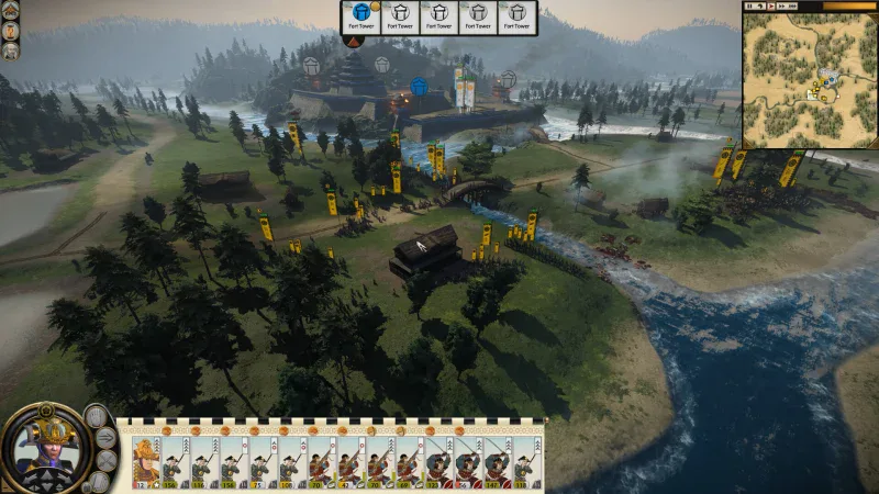 Armies close in on a hilltop castle beside a river in Total War: Shogun 2 Complete Edition
