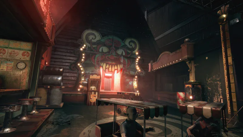 A creepy funfair with a giant clown face and puppet figures in The Outlast Trials