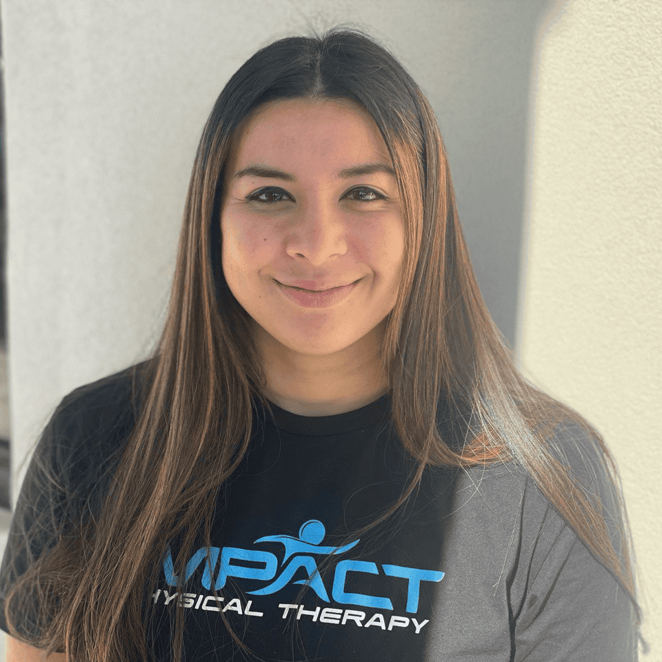 Impact Physical Therapy team member smiling outdoors.