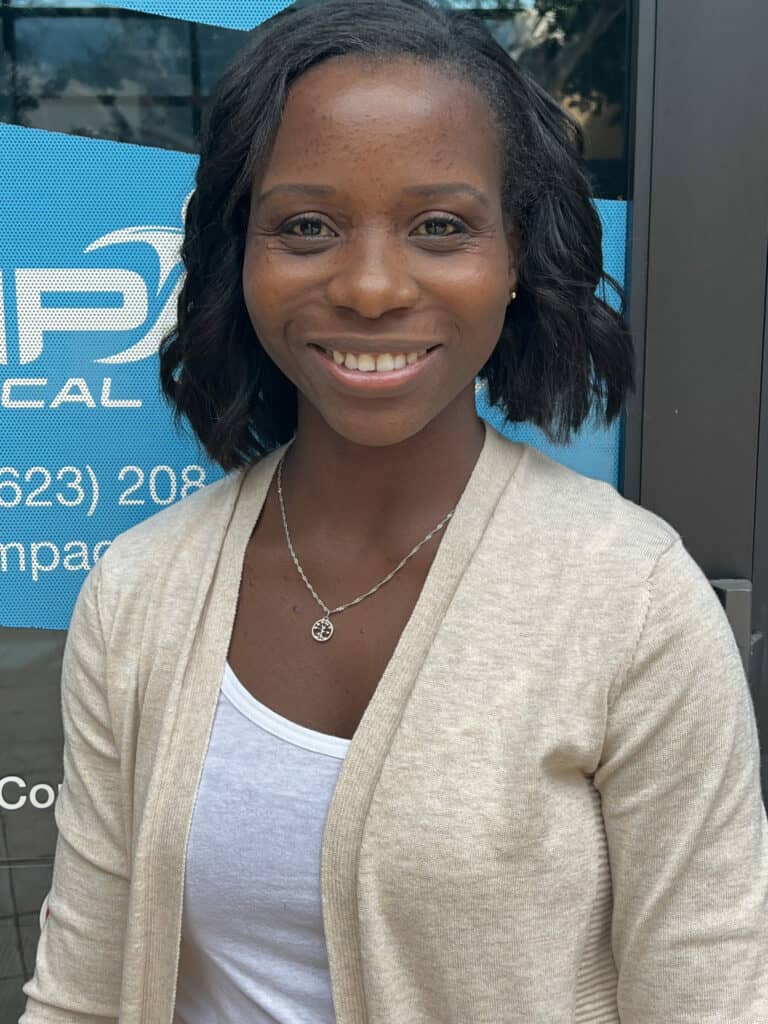 Smiling woman at Impact Physical Therapy clinic.