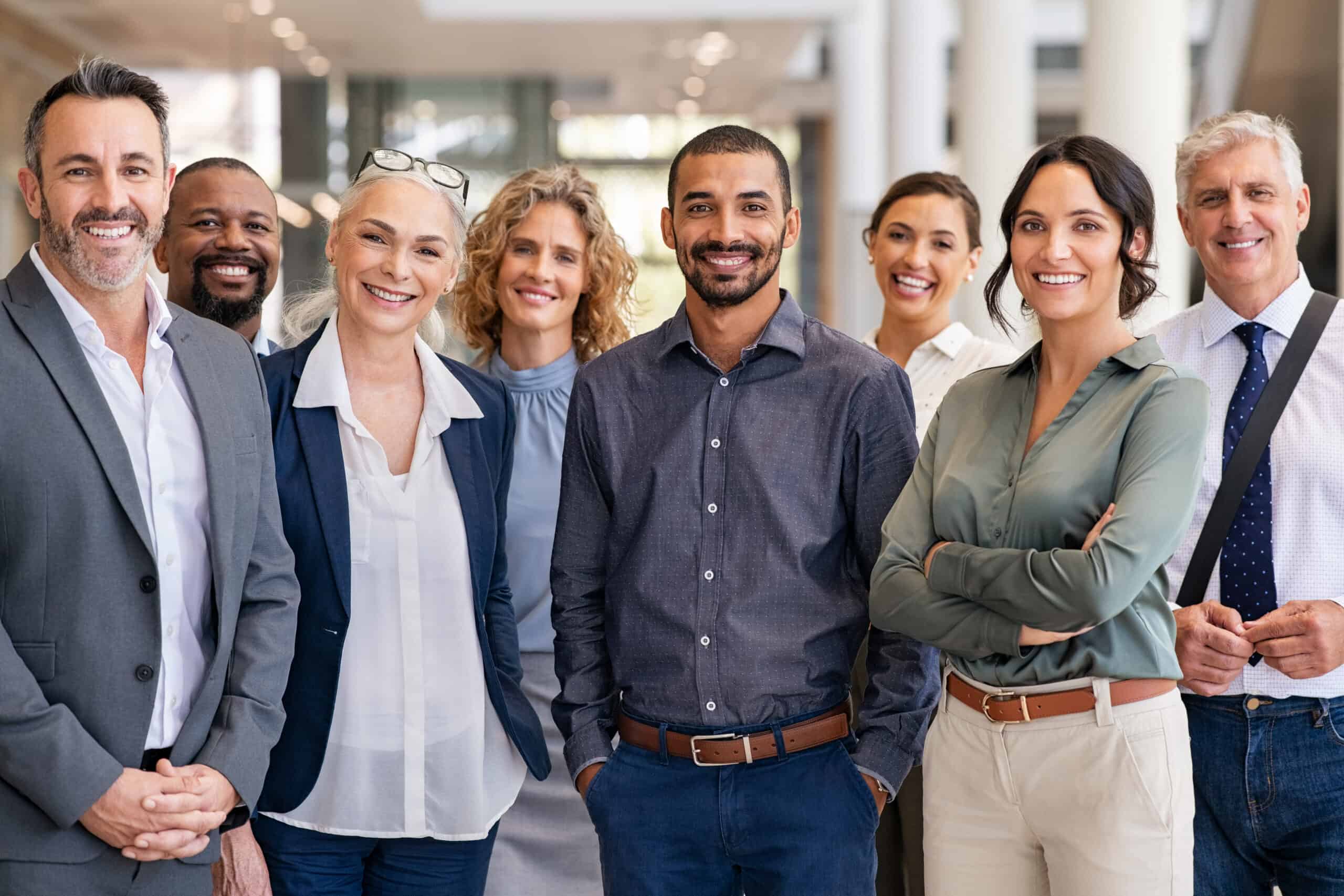 Diverse professional team smiling, showing confidence and independence at work for success.