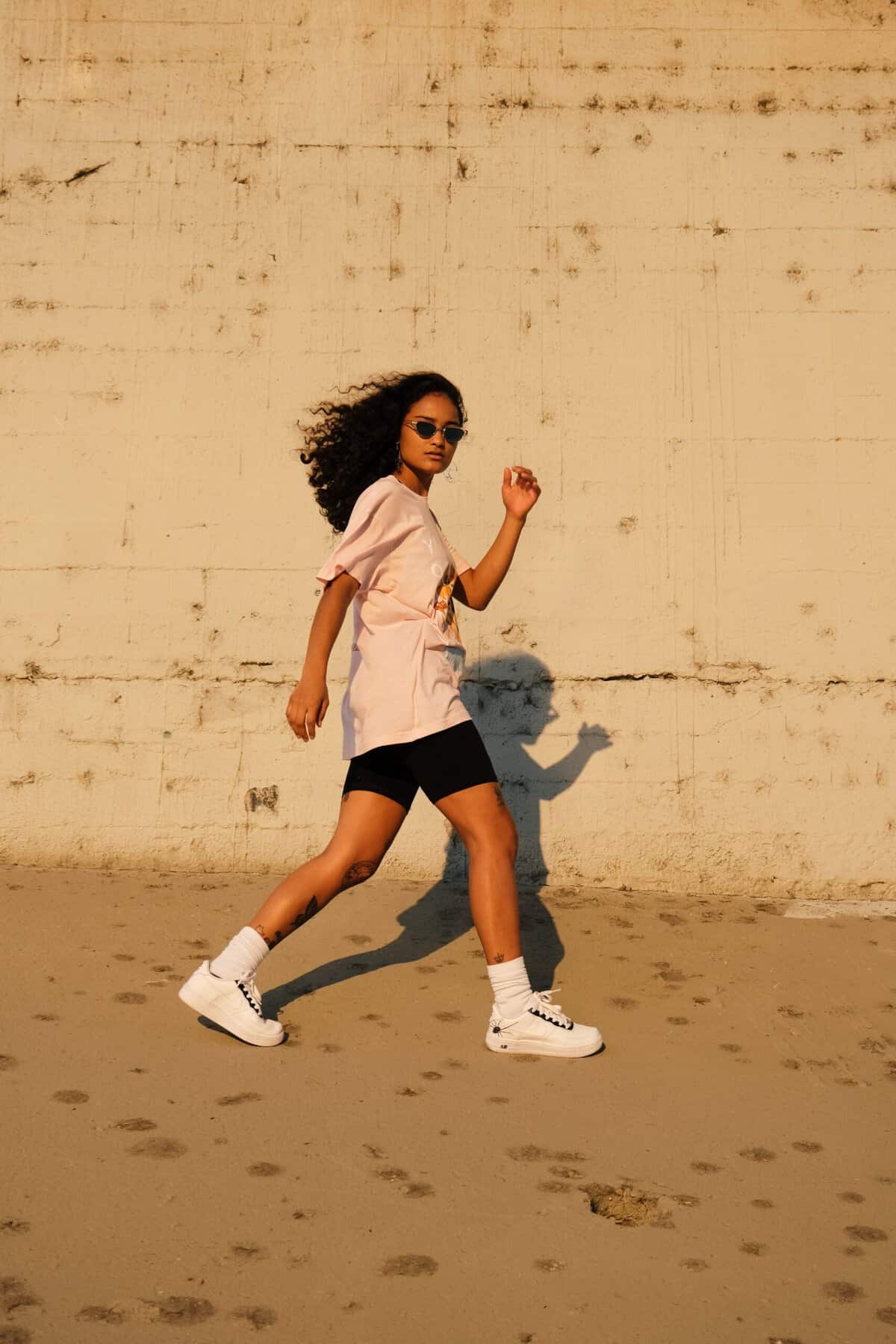 Woman walking briskly outdoors, representing movement to increase energy