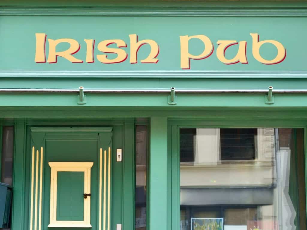 Colorful Irish takeaway shop with green exterior and vibrant sign.
