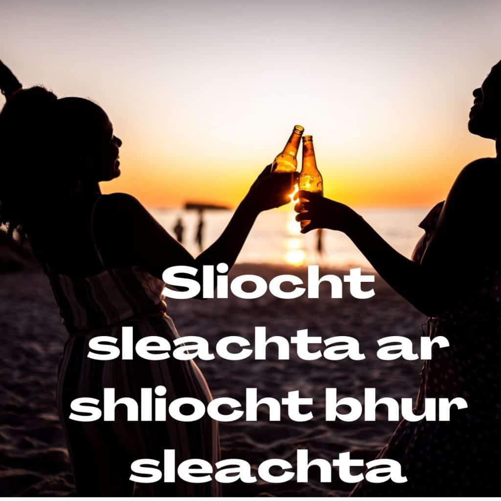 Clinking beer bottles at sunset on the beach in Ireland.