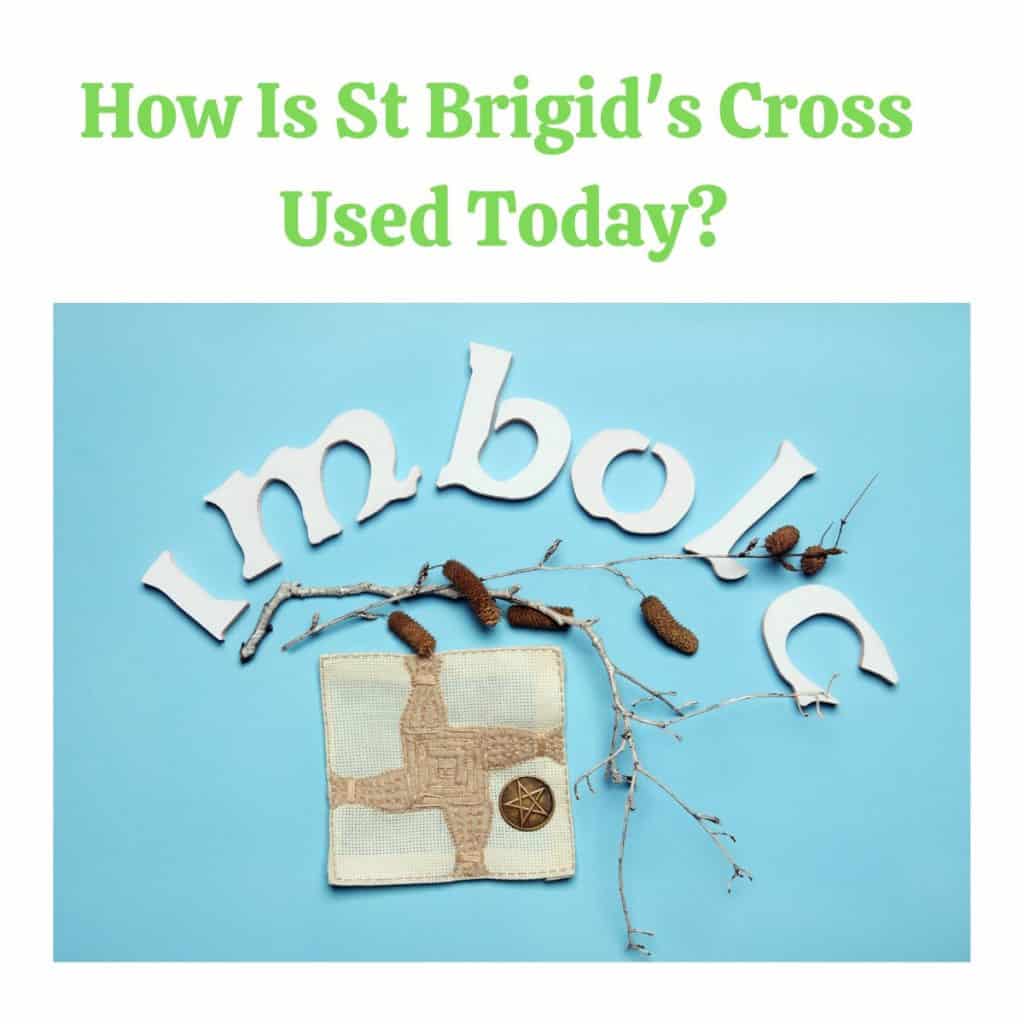 Ancient St Brigid's Cross made of straw on blue background.