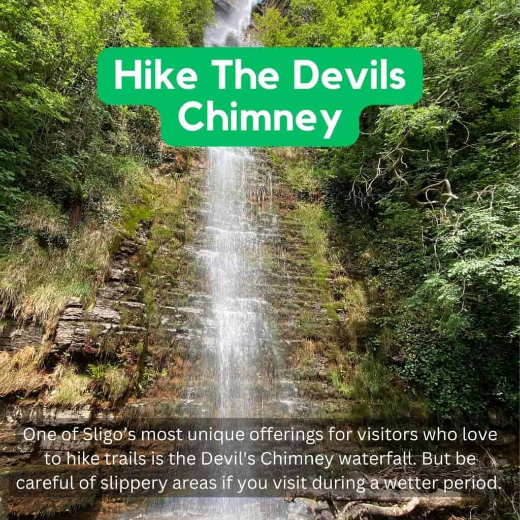 Devil's Chimney waterfall in Sligo surrounded by lush greenery.