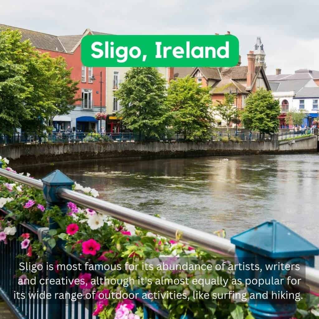 Sligo riverfront with colorful buildings and lush trees in Ireland.
