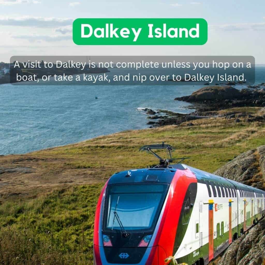 Dalkey Island viewed from the coast of Ireland with a train in the foreground.
