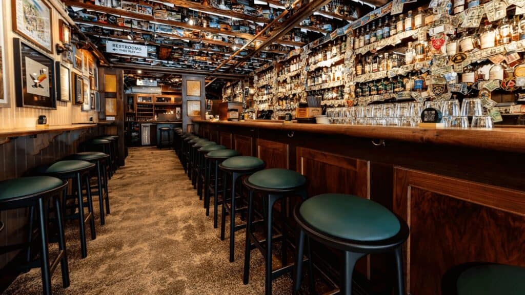 Rustic Irish pub interior with bar counter, seating, and decor celebrating Irish culture and heritage.