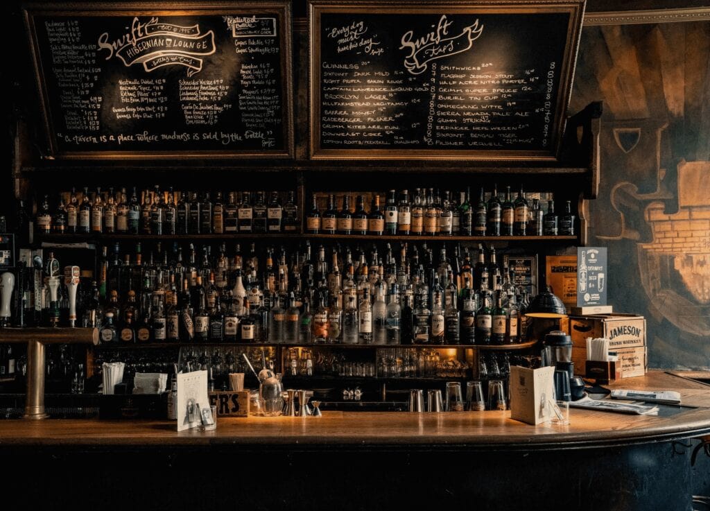 Rows of whiskey bottles and a chalkboard menu at a cozy Irish pub bar in Dublin, Ireland.