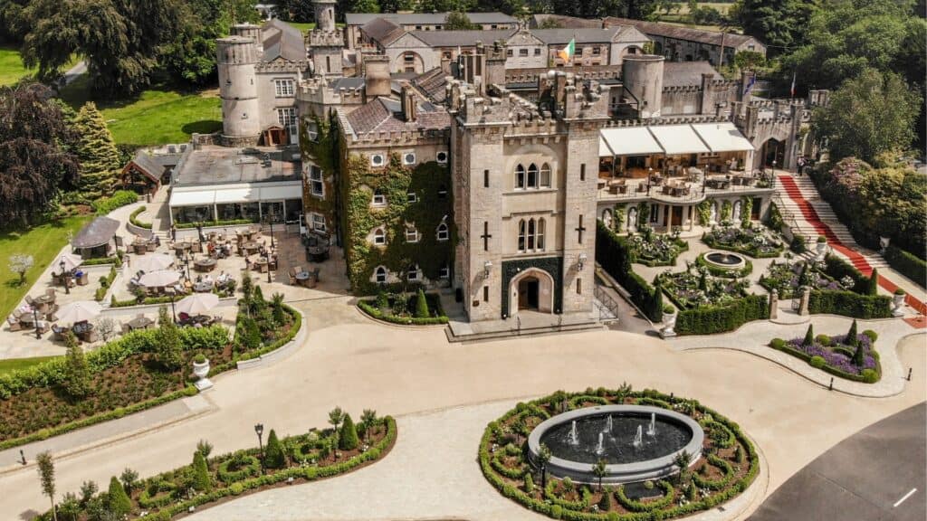 Luxurious Irish castle with beautiful gardens and outdoor dining areas.