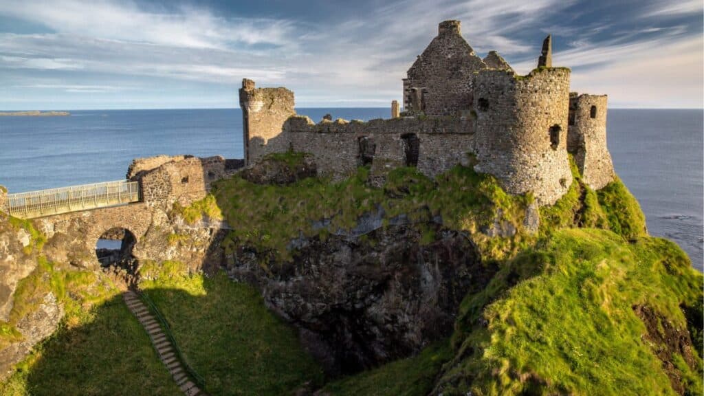 Ancient Irish castle overlooking the Atlantic coast on a sunny day.