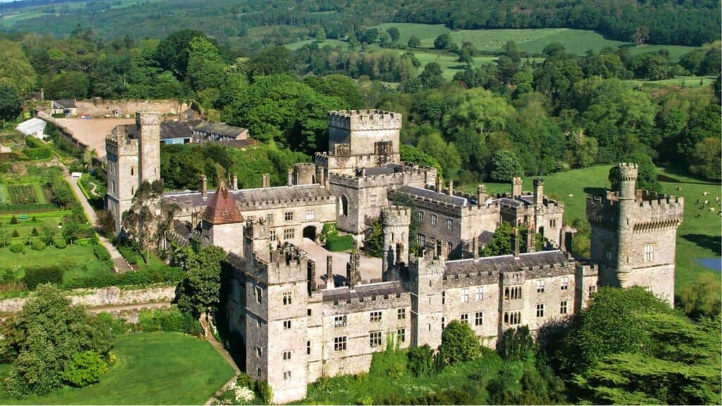 Majestic Irish castle surrounded by lush green landscape and rolling hills.